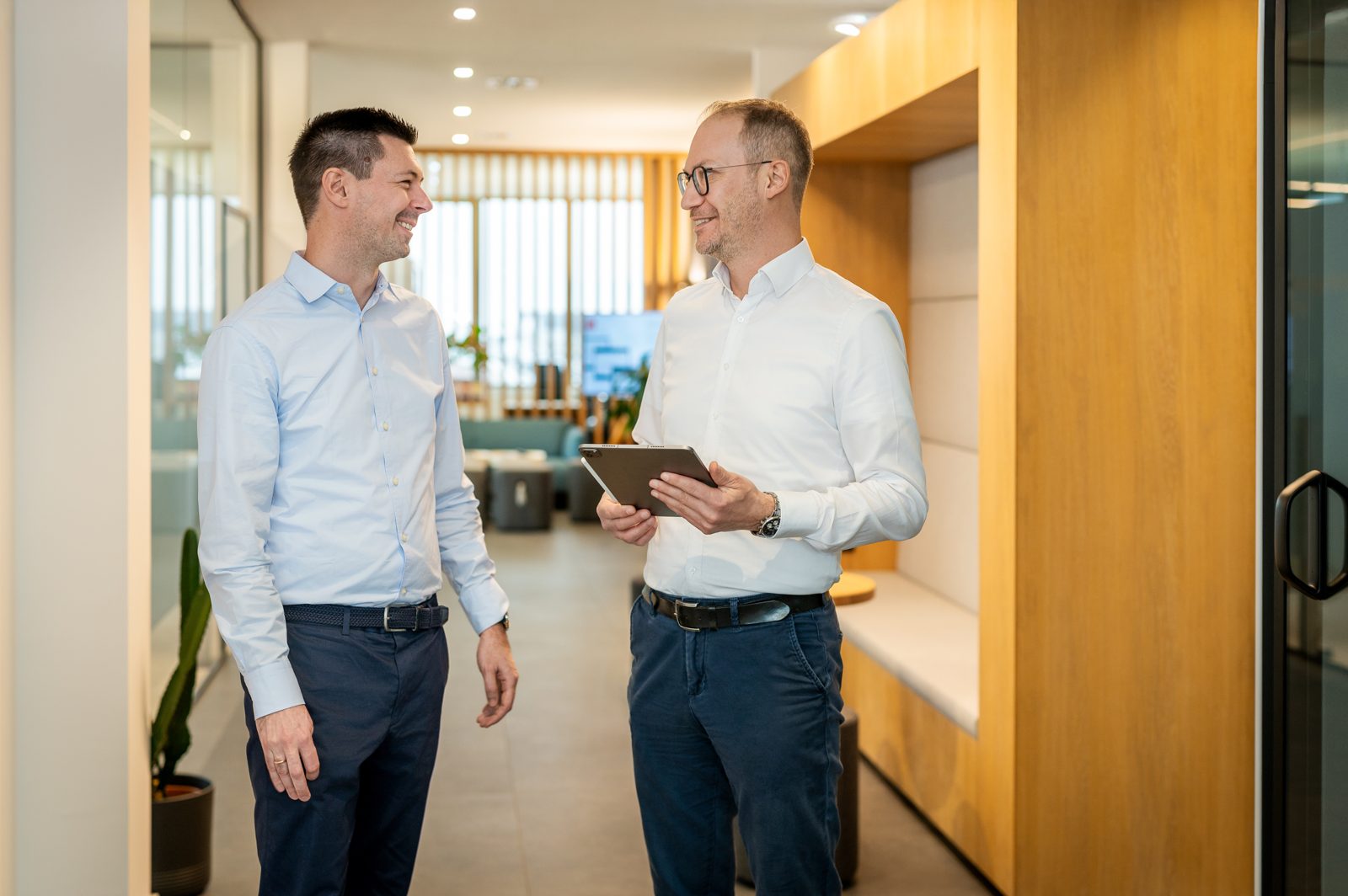 Two team members in conversation in the Denovo office